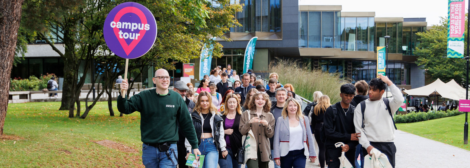 A group of happy prospective students on a campus tour at the University of Stirling