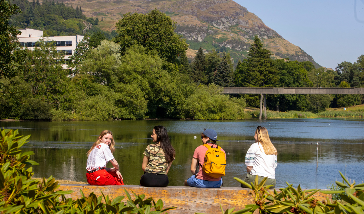 Students sitting at the loch