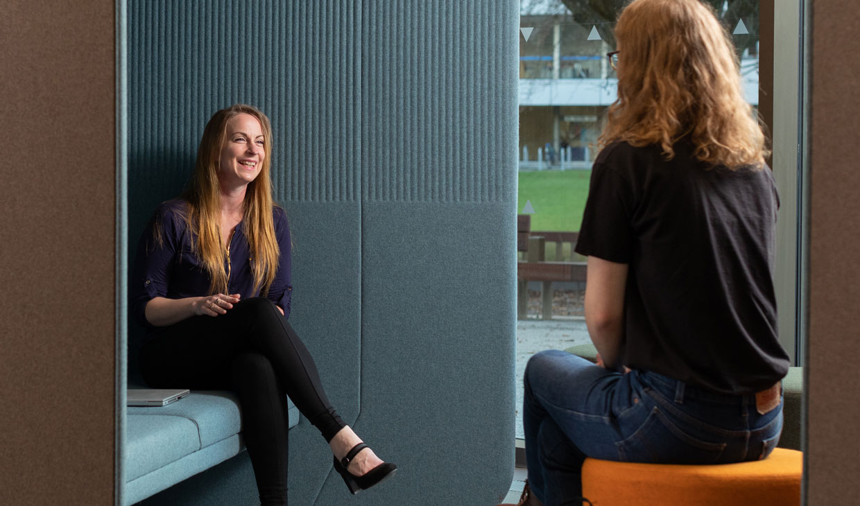A woman talking to a student at the new Student Services Hub