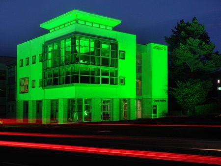 Cottrell building lit up with green light