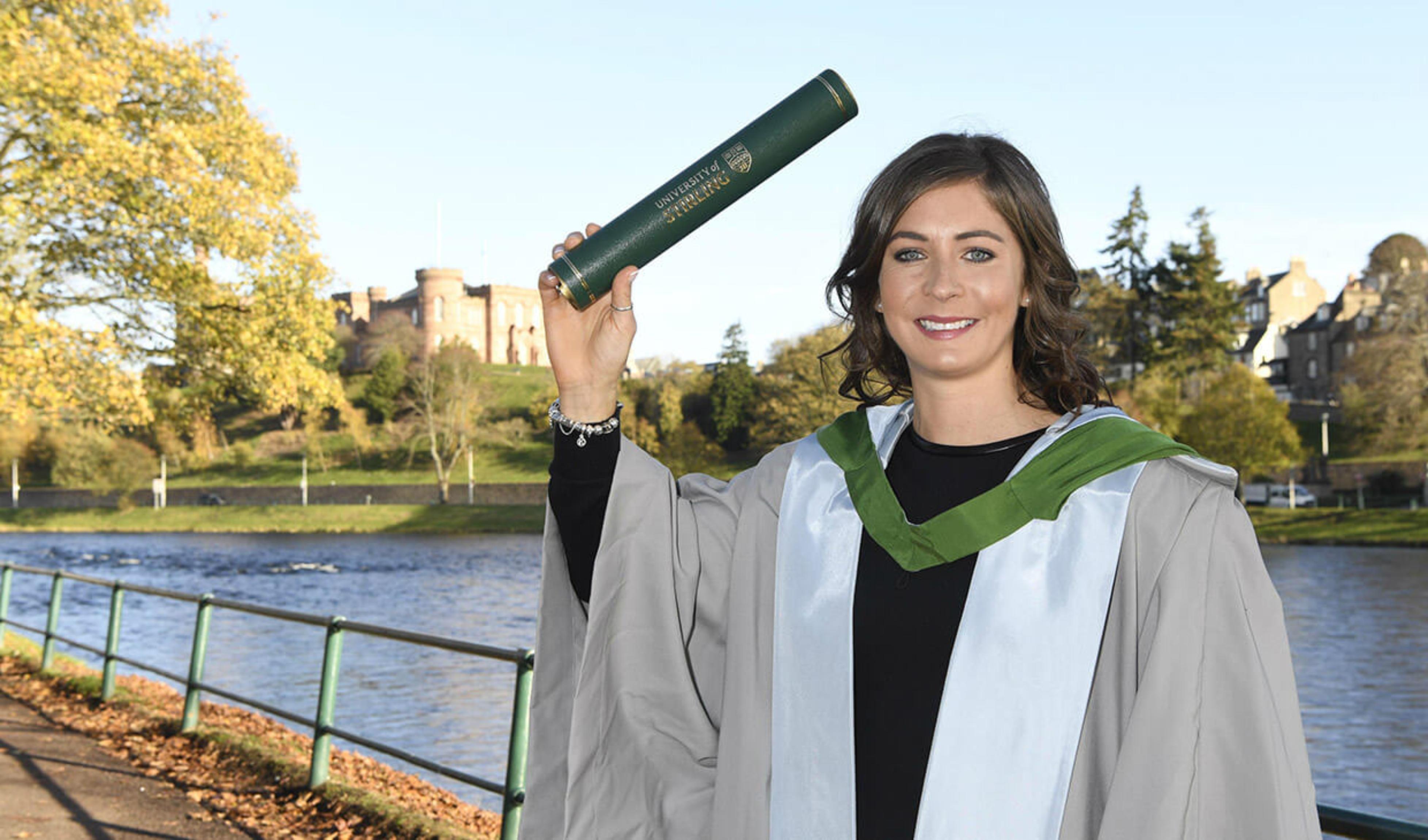Image of Eve Muirhead with graduation scroll