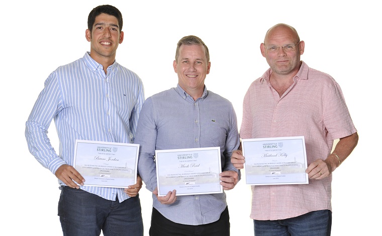 Group of three men with certificates