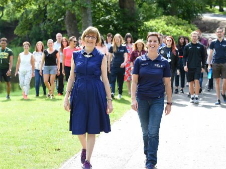 The University’s Professor Maggie Cusack, Dean of the Faculty of Natural Sciences, and Cathy Gallagher, Executive Director of Sport, lead participants on a final celebratory walk around Campus