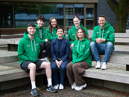 2022-23 Volunteer Zambia Student volunteers sit with Cathy Gallagher, Executive Director of Sport