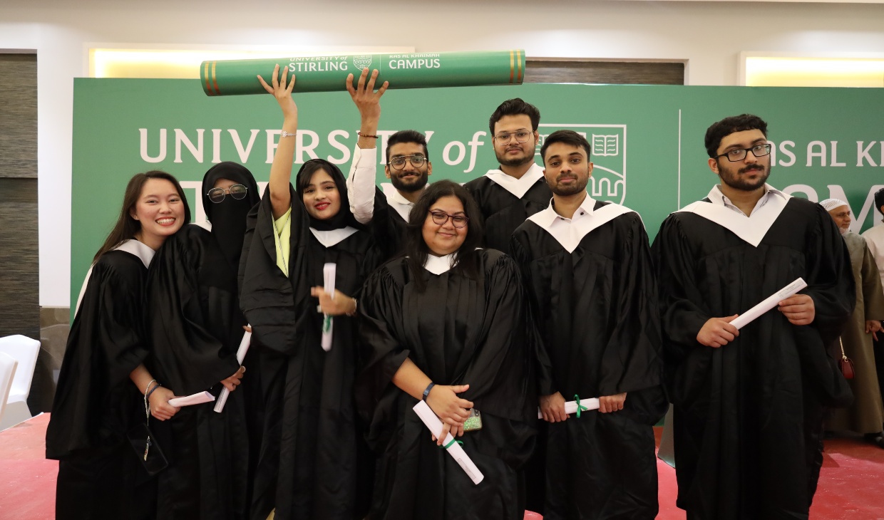 Students at the University of Stirling's UAE campus celebrate their graduation.