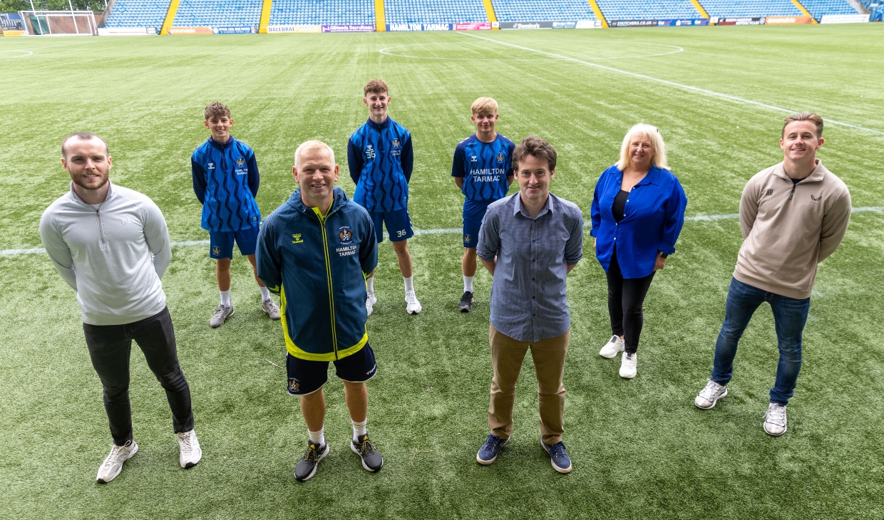 Wellbeing Coaches, Care Visions staff, Charlie Adams and youth players photographed on the pitch at Rugby Park
