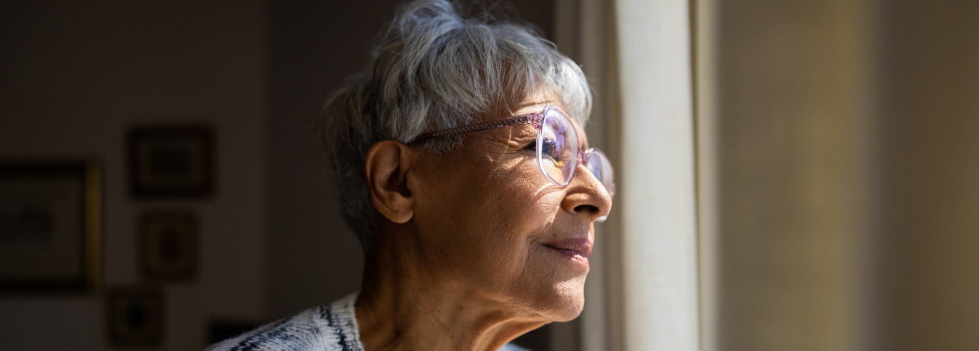 Older person looks out of window