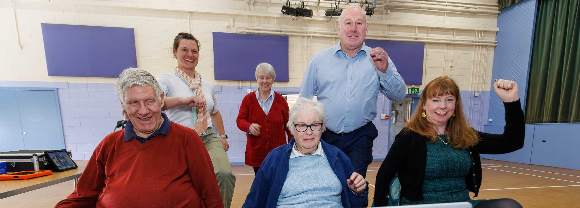 A group of older people take part in an online movement class