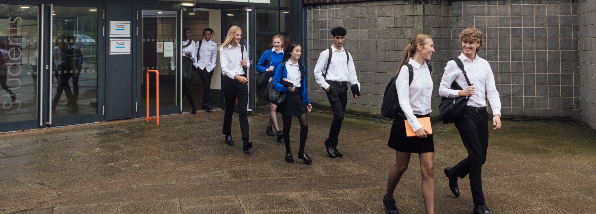School pupils walk out of a school building