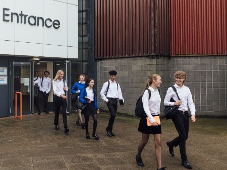 School pupils walk out of a school building