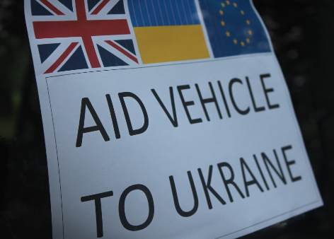 A poster on the front of a Jeep with the words 'Aid Vehicle to Ukraine'