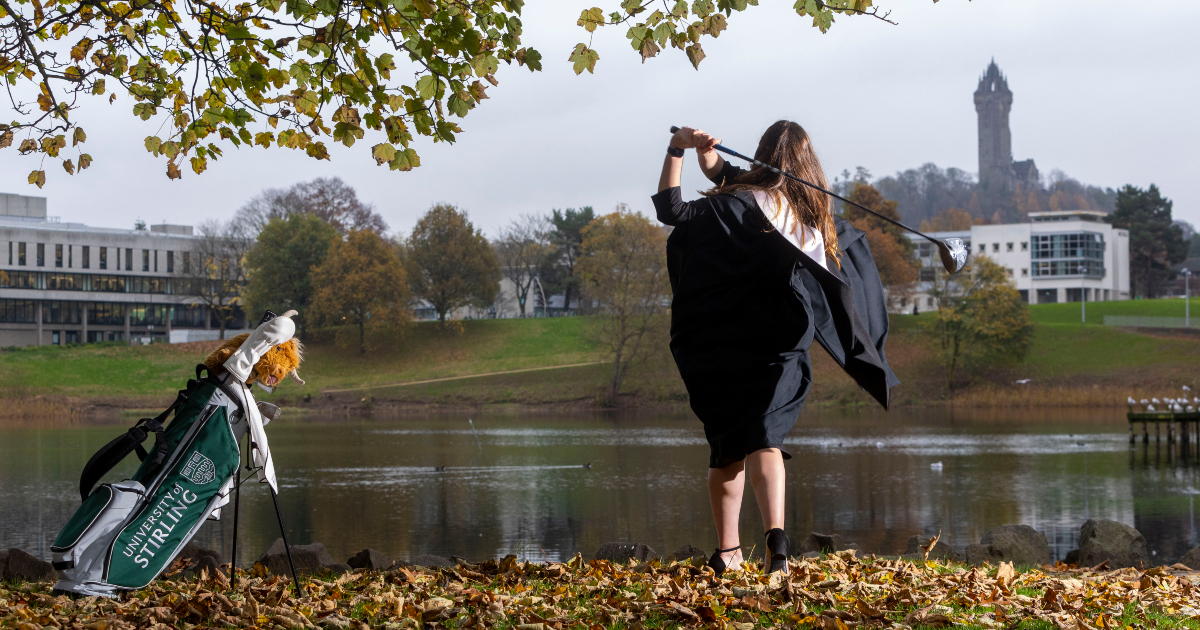 Lorna McClymont swinging club at the University of Stirling loch.