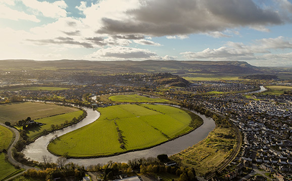 River meandering fields and a town